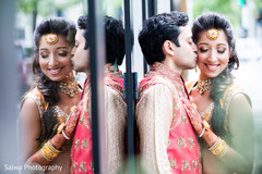 Great capture of Indian bride and groom reflecting on a glass door. Great capture of Indian bride and groom reflecting on a glass door.
