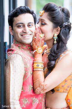 Indian bride telling a secret to Indian groom's capture. Indian bride telling a secret to Indian groom's capture.