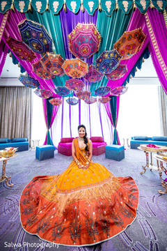 Stunning capture of Indian bride on her mehndi lengha at the mehndi mandap. Stunning capture of Indian bride on her mehndi lengha at the mehndi mandap.
