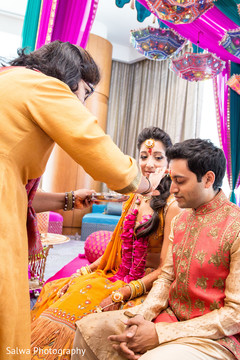 Gorgeous Indian groom getting the red kum-kum mark. Gorgeous Indian groom getting the red kum-kum mark.