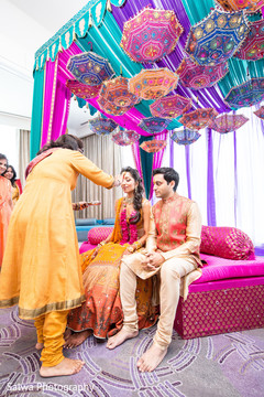 Lovely Indian bride getting the red kum-kum mark. Lovely Indian bride getting the red kum-kum mark.