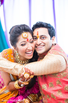 Indian bride and groom hugging each other while on the mehndy celebration. Indian bride and groom hugging each other while on the mehndy celebration.