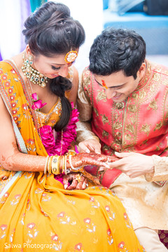 Lovely Indian wedding couple looking at mehndi art. Lovely Indian wedding couple looking at mehndi art.