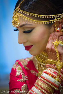 Happy Indian bride putting her jewels on. Happy Indian bride putting her jewels on.