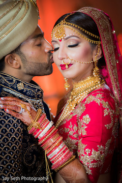 Lovely Indian groom kissing bride photo session. indian wedding ceremony fashion,indian bride and groom,indian wedding hair and makeup