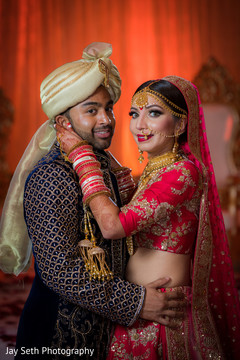 Gorgeous Indian bride and groom looking at camera capture. indian wedding ceremony fashion,indian bride and groom,indian wedding hair and makeup