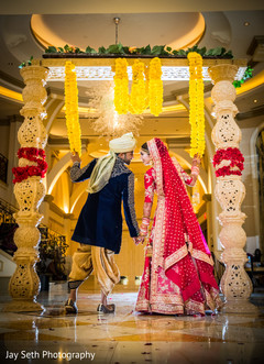 Lovely Indian bride and groom holding hands. indian wedding ceremony fashion,indian bride and groom,indian wedding hair and makeup