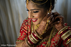 Dazzling indian bride putting earrings on indian wedding gallery,indian bride getting ready,bridal jewelry