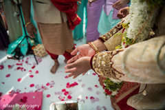Indian couple making offerings to sacred fire indian wedding ceremony,indian wedding ceremony photography,indian bride and groom