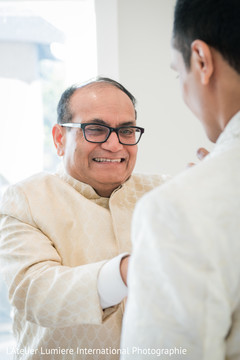 Indian groom getting help when getting ready for ceremony. Indian groom getting help when getting ready for ceremony.