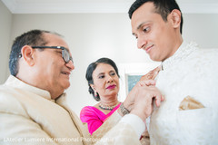 Indian groom being helped by parents to get ready. Indian groom being helped by parents to get ready.