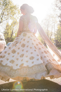 Dreamy Indian bride's capture posing outdoors with wedding dress. Dreamy Indian bride's capture posing outdoors with wedding dress.