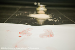 The alta ritual, where the bride steps on alta to enter the grooms house. indian wedding ceremony,indian wedding ritual,indian bride ritual,alta red footsteps