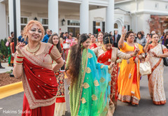 Cheerful Indian wedding family dance during baraat outdoors photography.