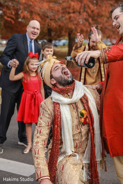 Cheerful Indian groom outdoors photography.