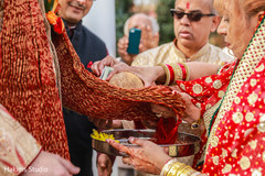 Indian room bringing the coconut for wedding ceremony during baraat ritual.