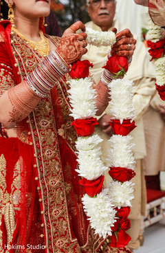 Indian bride putting flower garland to groom. Indian bride putting flower garland to groom.