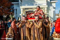 Emotional Indian bride being carried on a palanquin by groomsmen. Emotional Indian bride being carried on a palanquin by groomsmen.