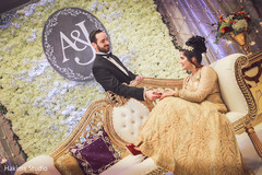 Indian bride and groom posing at their wedding reception capture. indian wedding fashion,indian bride and groom,indian wedding traditional outfits,mandap