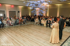 Indian bride and groom giving a speech for their wedding reception. indian wedding reception fashion,indian bride and groom,indian wedding venue