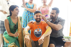 Indian groom is smeared in yellow turmeric paste at his first wedding ceremony ritual Indian groom is smeared in yellow turmeric paste at his first wedding ceremony ritual