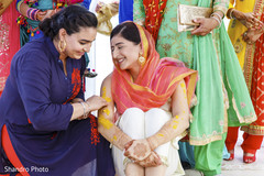 Indian wedding ritual of painting the bride with yellow turmeric paste Indian wedding ritual of painting the bride with yellow turmeric paste