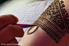 Indian bride having her Mehndi art done. mehndi,golden mehndi art,indian bride mehndi