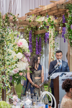 Indian groom giving speech with bride during wedding reception. indian wedding cake,indian bride and groom,indian wedding fashion