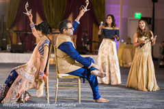 Indian bride and groom playing a game during the garba celebration. Indian bride and groom playing a game during the garba celebration.