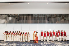 Lovely Indian couple posing outdoors with bridesmaids and groomsmen. Lovely Indian couple posing outdoors with bridesmaids and groomsmen.