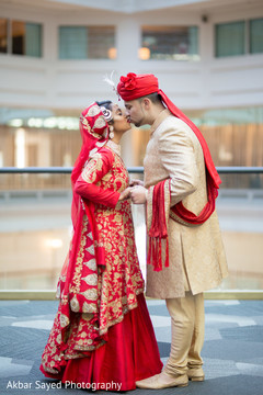 Lovely Indian groom kissing bride photo session. indian wedding ceremony fashion,indian bride and groom,indian wedding traditional outfits
