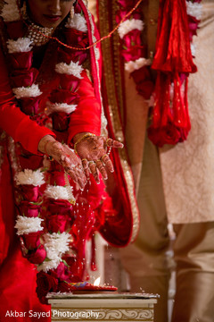 Indian bride throwing the rice on the sacred fire. Indian bride throwing the rice on the sacred fire.