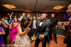 Indian wedding guests rocking the dance floor together with bride. indian wedding guests rocking the dance floor