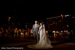 Lovely Indian bride on her white dress posing with her groom. Lovely Indian bride on her white dress posing with her groom.