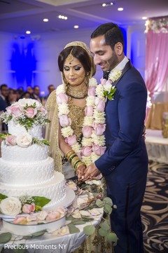 Cutting the cake scene indian wedding reception,indian wedding reception photography,indian wedding cake
