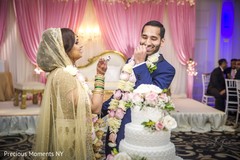 Indian newlyweds fun scene indian wedding reception,indian wedding reception photography,indian wedding cake