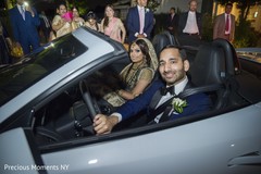 Indian newlyweds inside wedding car indian wedding reception,indian wedding reception photography,indian bride and groom
