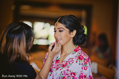 Lovely Indian bride getting her lipstick on for the wedding. Lovely Indian bride getting her lipstick on for the wedding.