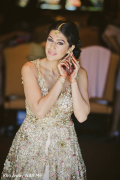 Indian bride putting earrings on. Indian bride putting earrings on.