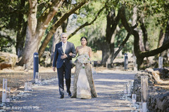 Gorgeous Indian bride walking in with her father at the wedding ceremony. Gorgeous Indian bride walking in with her father at the wedding ceremony.