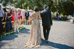 Beautiful Indian bride waking holding hands with parent to ceremony. Beautiful Indian bride waking holding hands with parent to ceremony.