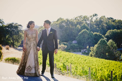 Dazzling Indian bride and groom walking holding hands. Dazzling Indian bride and groom walking holding hands.