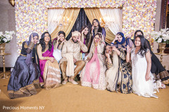 Lovely Indian bride and groom posing funny with bridesmaids capture. Lovely Indian bride and groom posing funny with bridesmaids capture.