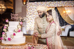 Lovely capture Indian bride and groom cutting cake together. Lovely capture Indian bride and groom cutting cake together.