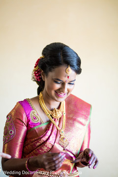 Indian bride putting her jewelry on Indian bride putting her jewelry on