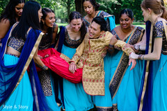 Fun moment of Indian groom being lift up by bridesmaids. Fun moment of Indian groom being lift up by bridesmaids.