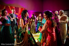 Indian bride enjoying a dance at her sangeet celebration. Indian bride enjoying a dance at her sangeet celebration.