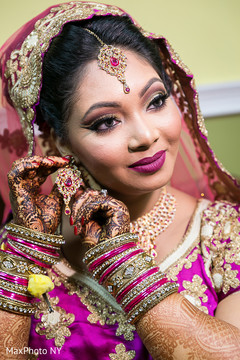Lovely indian bride putting her jewelry on Lovely indian bride putting her jewelry on