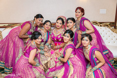 Glamorous indian bride posing with bridesmaids Glamorous indian bride posing with bridesmaids