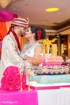 Sweet indian couple about to cut their wedding cake Sweet indian couple about to cut their wedding cake